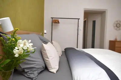 a bedroom with a bed with a vase of flowers at Central one bedroom apartment in Prague