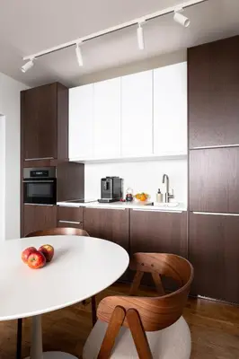 a kitchen with a white table and a table and chairs at Modern studio with terrace in Prague