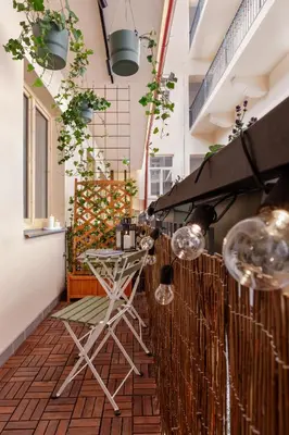 a balcony with a table and chairs on a patio at Modern studio with terrace in Prague