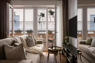 a living room with a couch and a table at Modern studio with terrace in Prague