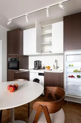 a kitchen with a white table and a refrigerator at Modern studio with terrace in Prague
