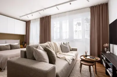 a living room with a couch and a bed at Modern studio with terrace in Prague