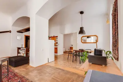 a living room with a table and chairs at Old Town Magical Stay Comfy 2BDR Historic House in Prague