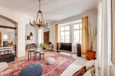 a living room with a couch and a tv at Old Town Magical Stay Comfy 2BDR Historic House in Prague