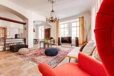 a living room with a red couch and a rug at Old Town Magical Stay Comfy 2BDR Historic House in Prague