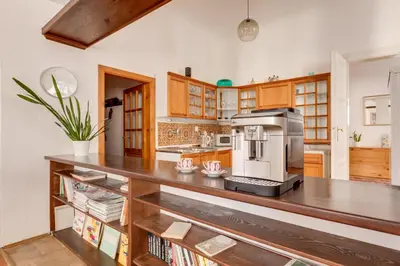 a kitchen with a large wooden counter top with a microwave at Old Town Magical Stay Comfy 2BDR Historic House in Prague