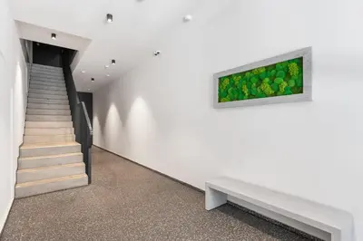 a bedroom with a bed and a desk and a kitchen at REAL Living by REFA Karlin 408 in Prague