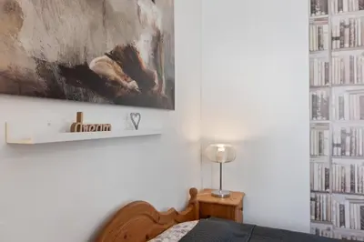 a bedroom with a bed and a painting on the wall at Cozy 2 Bedroom Flat in Prague in Prague