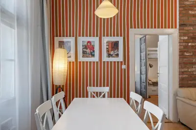 a dining room with a white table and chairs at Cozy 2 Bedroom Flat in Prague in Prague