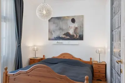 a bedroom with a bed and a painting on the wall at Cozy 2 Bedroom Flat in Prague in Prague