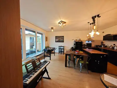 a living room with a piano and a dining room at Family, party Apartament in Prague