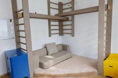 a room with a loft bed with a couch and a chair at Family, party Apartament in Prague