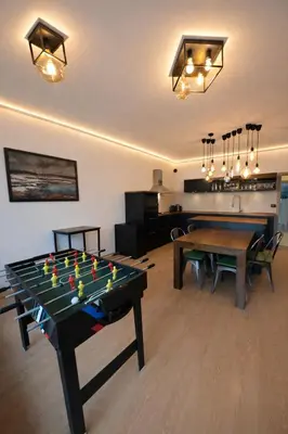 a living room with a ping pong table in it at Family, party Apartament in Prague