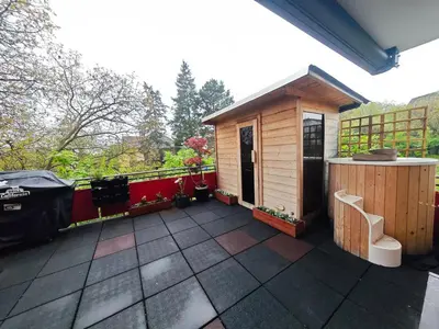 a deck with a small cabin with a bench at Family, party Apartament in Prague