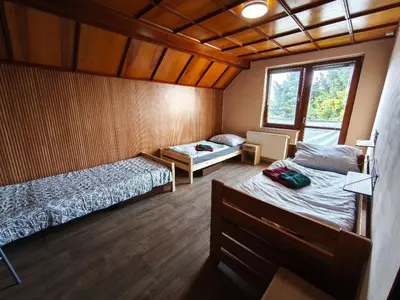 a bedroom with two beds and a window in it at Apartmány ŠTĚSTÍ in Bechlín