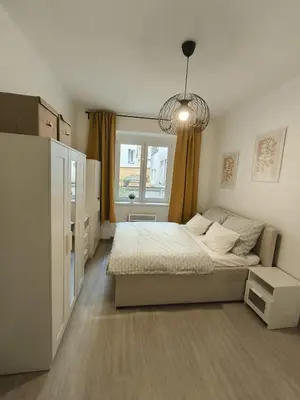 a small bedroom with a bed and a window at Apartmán Grébovka in Prague