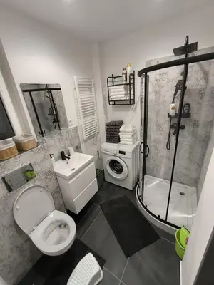 a bathroom with a toilet a sink and a shower at Apartmán Grébovka in Prague