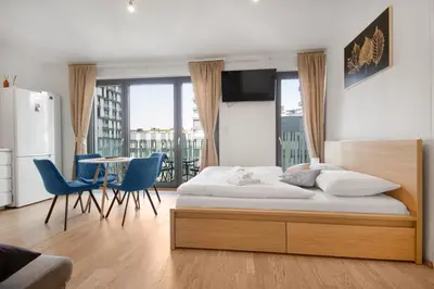 a bedroom with a bed and a table and chairs at Modern apartment with parking in Prague