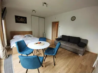 a bedroom with a bed and a table and chairs at Modern apartment with parking in Prague