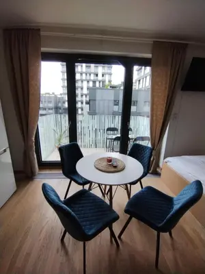 a room with a table and chairs and a bed at Modern apartment with parking in Prague