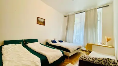 a bedroom with two beds and a window at Prague service Apartment - Central square location in Prague
