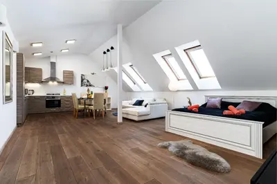 a bedroom with a bed and a kitchen with skylights at White Rabbit's Residence in Prague