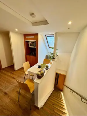 a kitchen with a table and chairs in a room at Klidné ubytování u Prahy in Sluhy