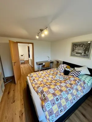 a bedroom with a large bed and a table at Klidné ubytování u Prahy in Sluhy