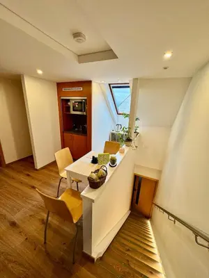 a kitchen with a table and chairs in a room at Klidné ubytování u Prahy in Sluhy