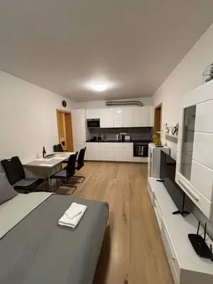 a kitchen and living room with a table and chairs at Royal Stay Wenceslas Square in Prague