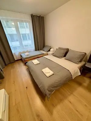 a bedroom with a large bed and a large window at Royal Stay Wenceslas Square in Prague