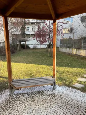 a wooden bench sitting under a gazebo in a park at Royal Stay Wenceslas Square in Prague