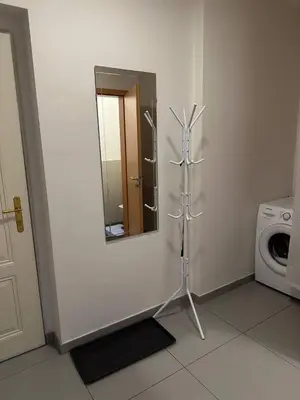a bathroom with a mirror and a washing machine at Royal Stay Wenceslas Square in Prague