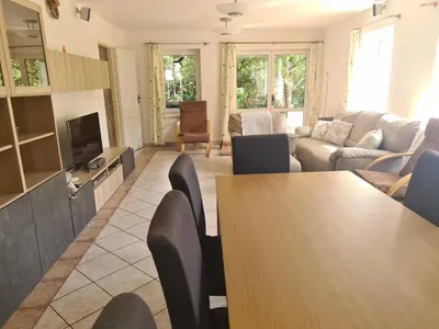 a living room with a table and a couch at Rodinný dům v Praze s bazénem in Prague