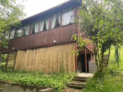 a wooden house with a bunch of windows at Chata Maruška na Sýkořici in Sýkořice
