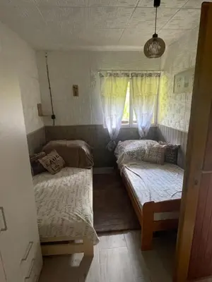 a room with two beds and a window at Chata Maruška na Sýkořici in Sýkořice