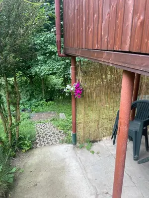 a bench sitting next to a fence with a flower at Chata Maruška na Sýkořici in Sýkořice