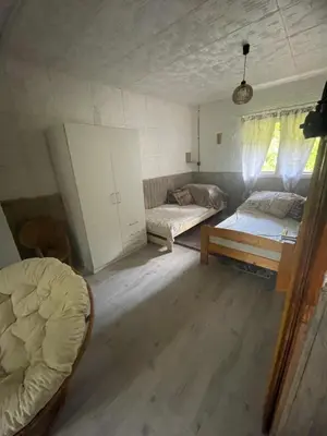 a room with two beds and a couch in it at Chata Maruška na Sýkořici in Sýkořice