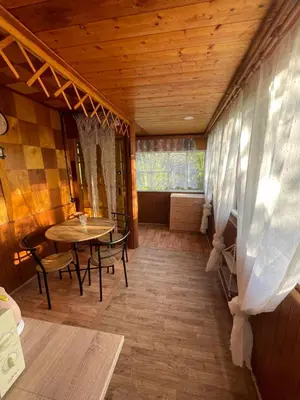 a room with a table and chairs and a wooden ceiling at Chata Maruška na Sýkořici in Sýkořice