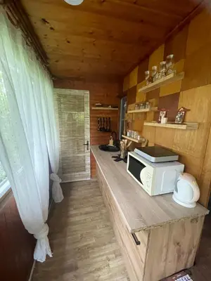 a kitchen with a counter with a microwave on it at Chata Maruška na Sýkořici in Sýkořice