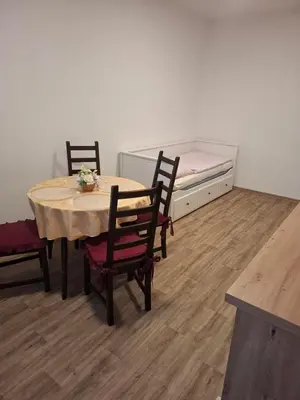 a room with a table and chairs and a bed at Apartmán Libochovice in Libochovice