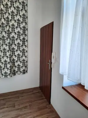 a room with a door and a curtain and a window at Apartmán Libochovice in Libochovice