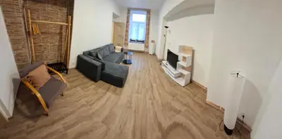 a living room with a couch and a tv at Apartmán Libochovice in Libochovice