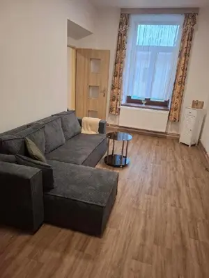 a living room with a couch and a table at Apartmán Libochovice in Libochovice