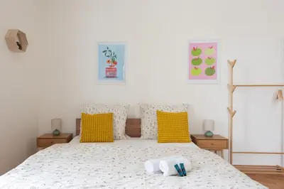 a bedroom with a bed with two towels on it at Central City Apartments in Prague