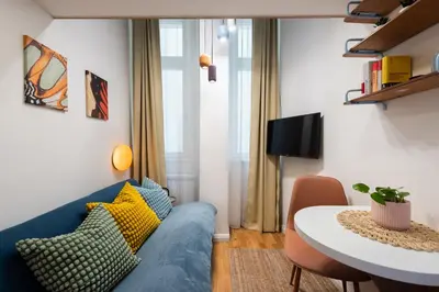 a living room with a blue couch and a table at Central City Apartments in Prague