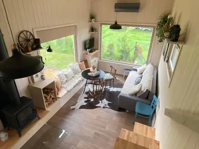 an aerial view of a living room with a couch and a fireplace at Tiny House in Stará Boleslav