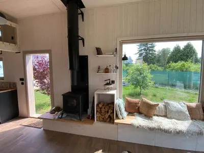a living room with a couch and a stove at Tiny House in Stará Boleslav