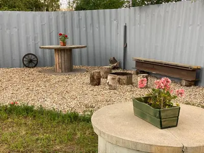 a garden with a table and a bench and flowers at Tiny House in Stará Boleslav