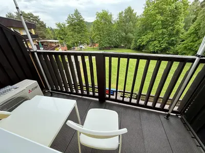 a balcony with a white table and two chairs at Apartmán Slapy - Ždáň in Slapy